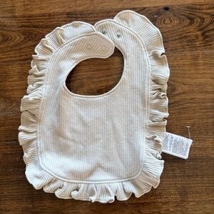 Baby gap cream bib ruffle edged new without tags. Cream/tan colored